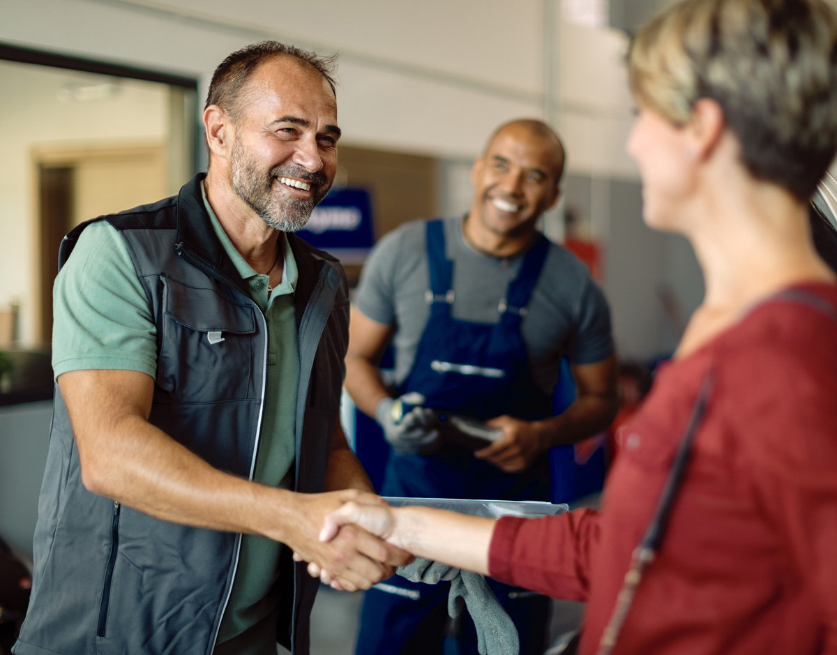 happy-auto-repairman-handshaking-with-customer